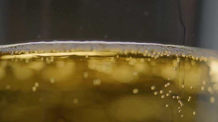 Bubbles are forming in a glass of beer