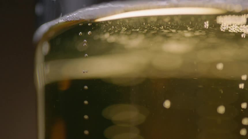 Bubbles are rising to the top of a beer glass