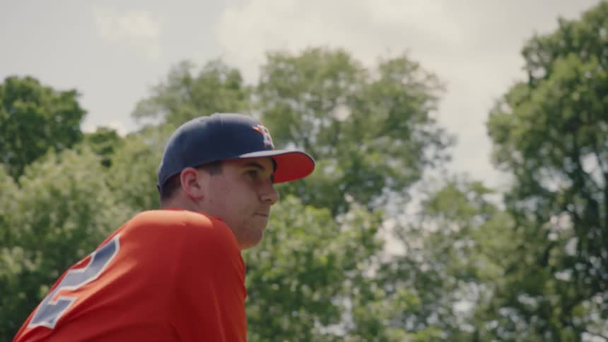 Man throws a baseball on a baseball field