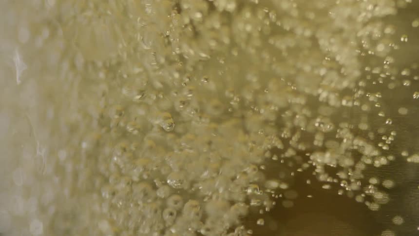 Beer is poured into a glass