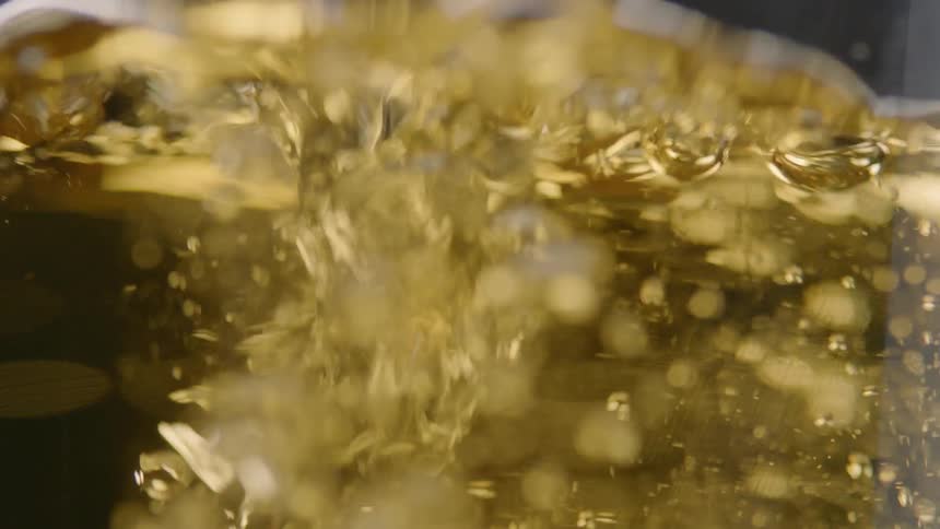 Beer is poured into a glass