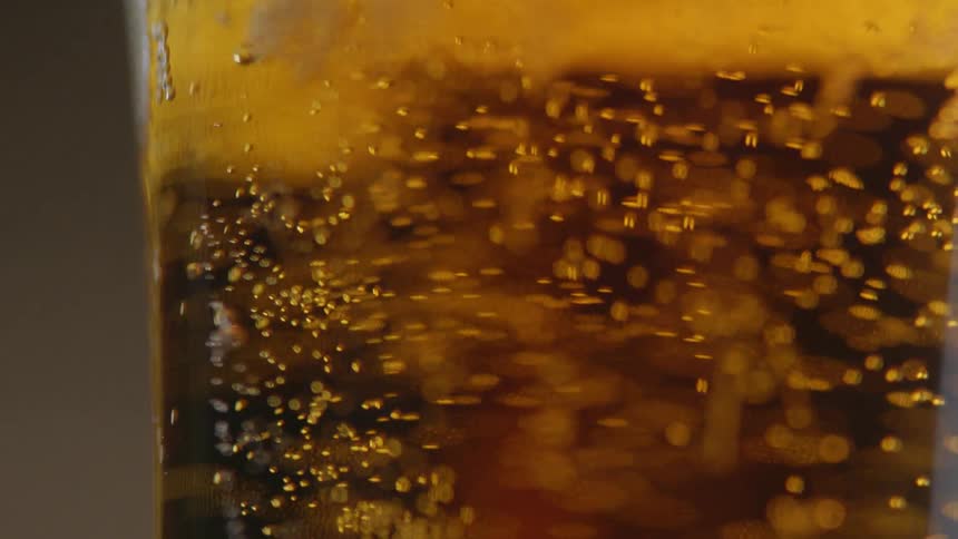 Bubbles are rising to the top of a beer