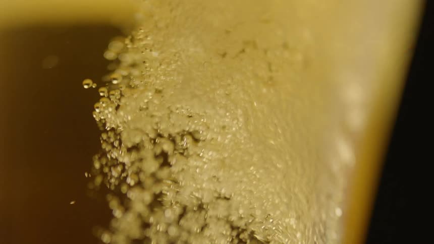 Beer is poured into a glass