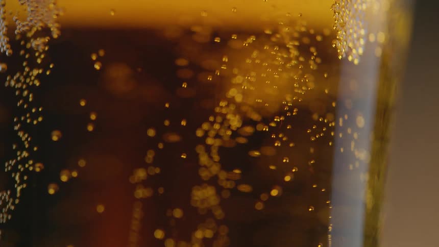 Bubbles rise to the top of a beer glass