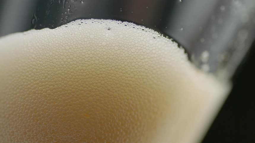 Beer is poured into a glass