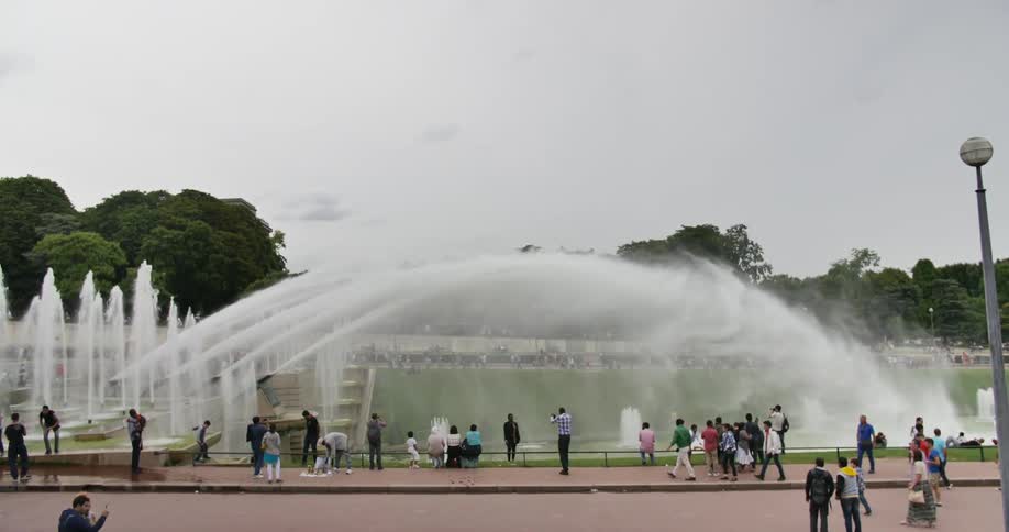 People stand and observe an elaborate water display