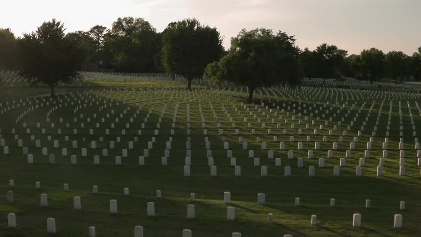 Headstones are displayed symmetrically in a cemetery