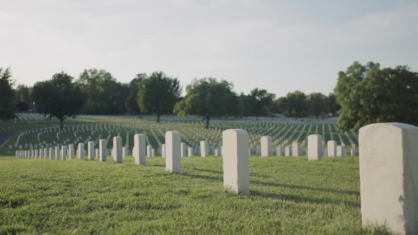 The cemetery is lined with small white tombstones