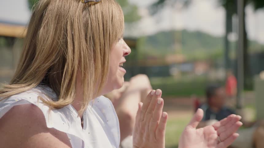 A woman is clapping at sports