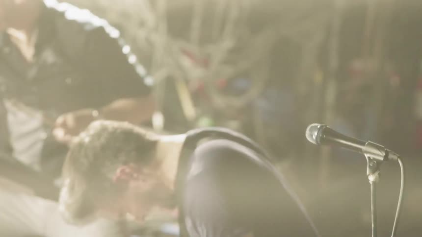 Guitarist and drummer play music on stage