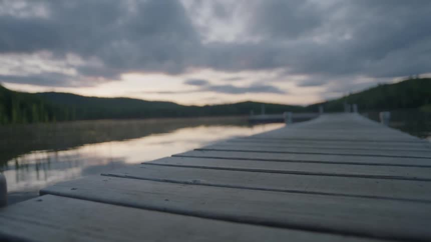 A fishing pier stretches over a pond