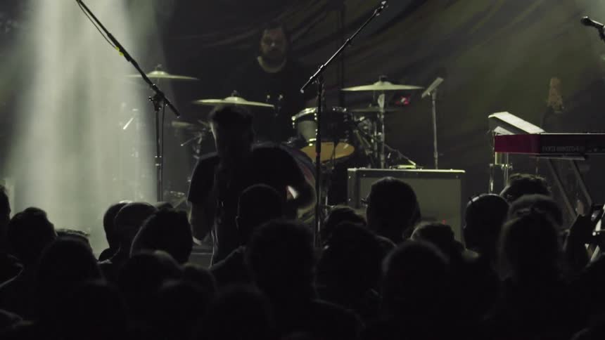 The crowd cheers as the singer jumps down from stage