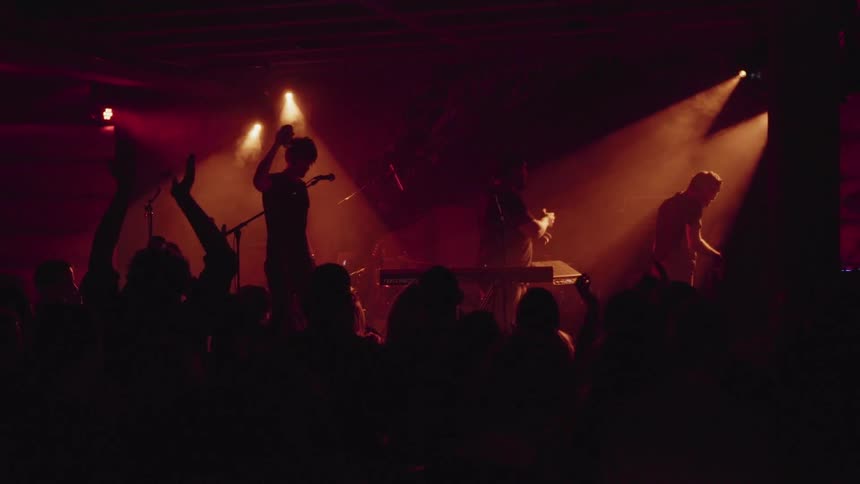 Musicians wave to crowd and walk off stage