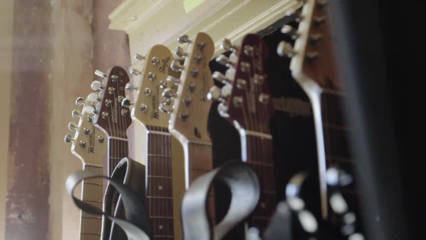 Guitars standing up in a row inside building
