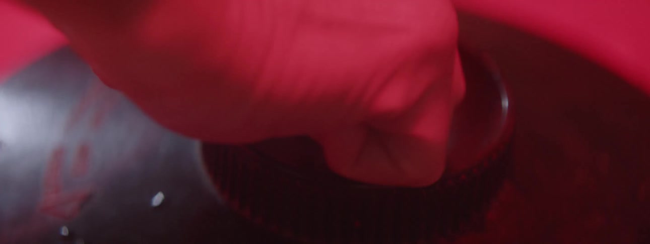 Person rotates film in a photo lab