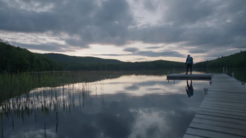 Man stands on a fishing pier