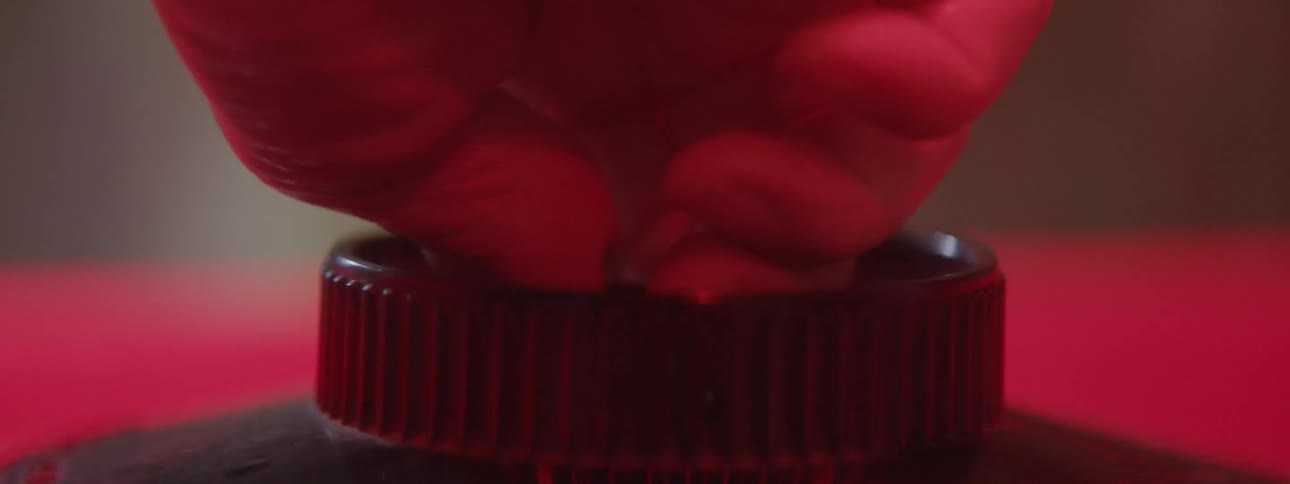 A woman adjusts a knob on a canister