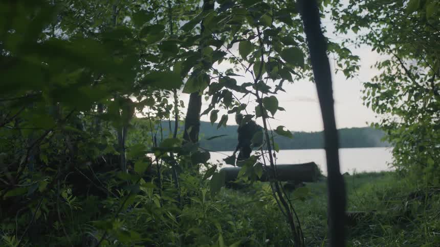 Hikers walks next to a mountain lake