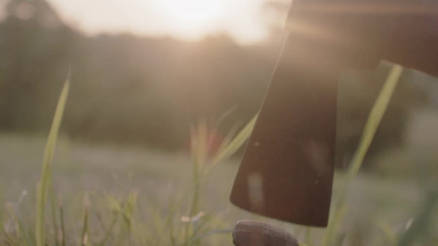 A metal spike is hammered into the ground