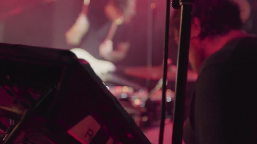 A drummer is playing drums with the help of the guitarist