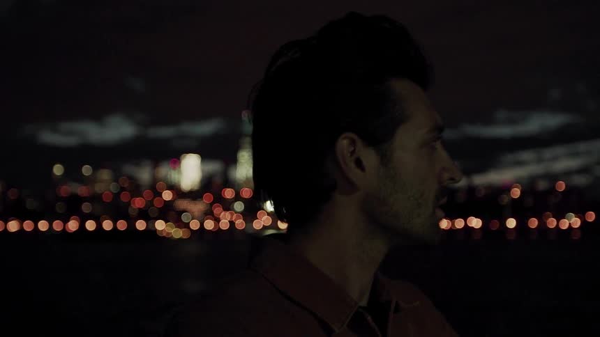 Men stands outside in a city at night