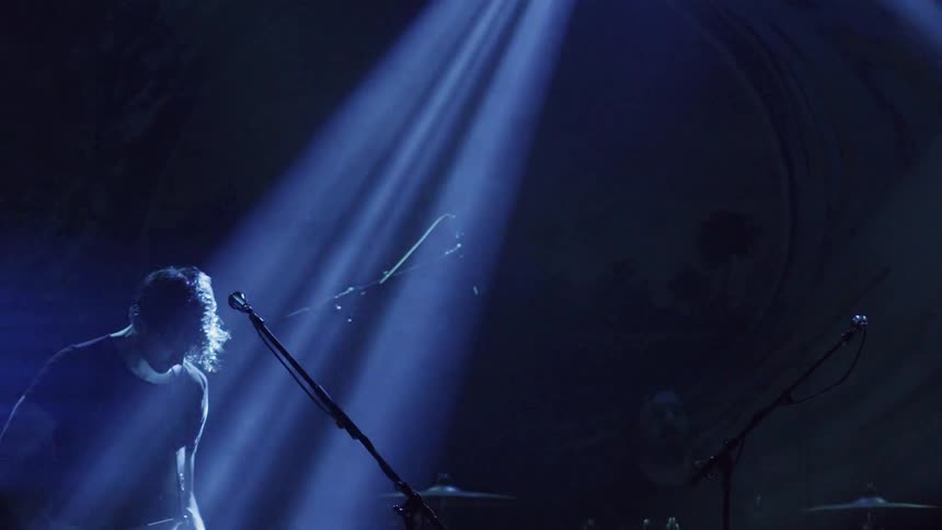 A man is playing guitar on stage