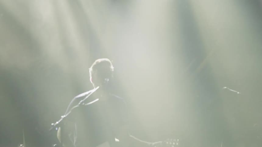 Crowd of people watching a band play on stage