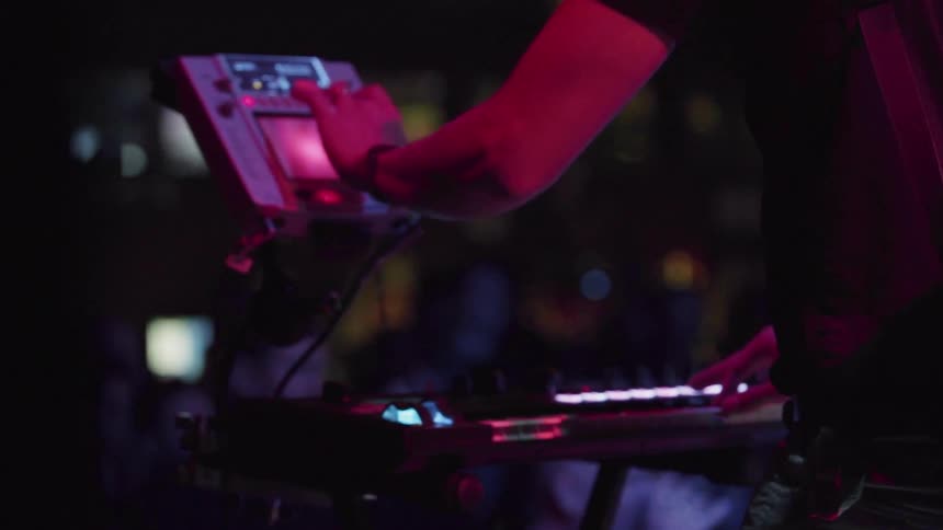 Musician plays a keyboard on stage