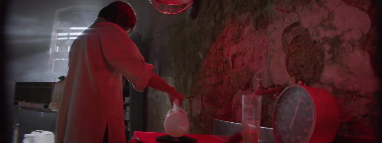 Woman pours liquid into a try in a lab