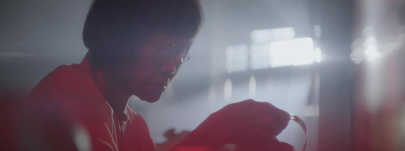 A woman develops film in a dark room