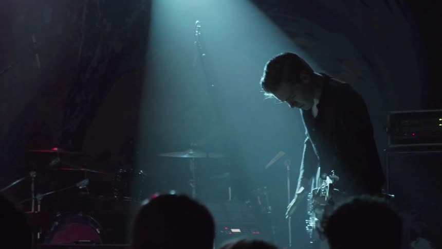 Band performs on stage in front of an audience
