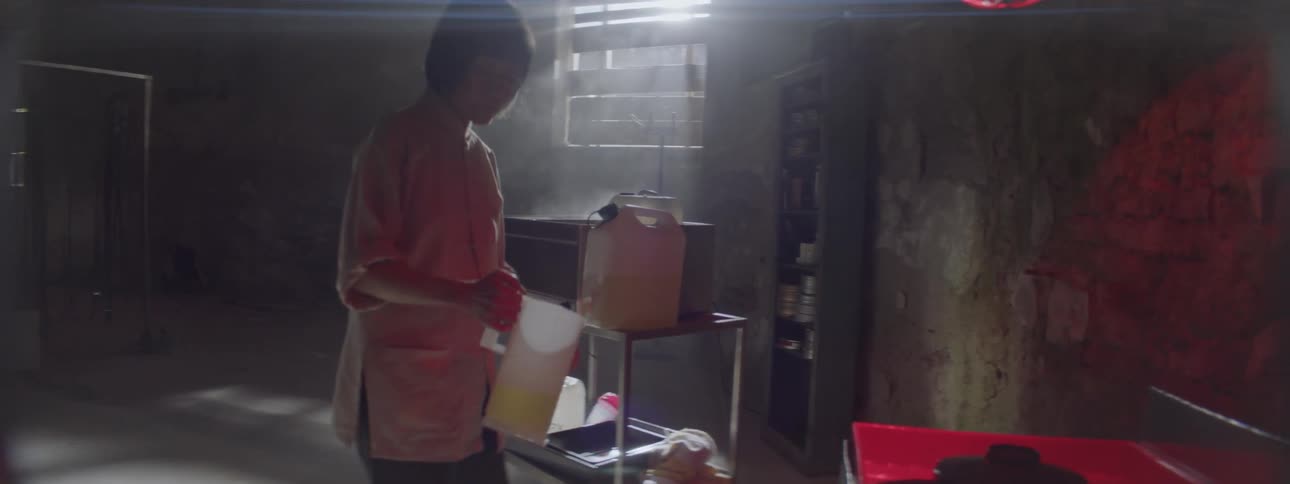Woman puts liquid in a pitcher in a lab