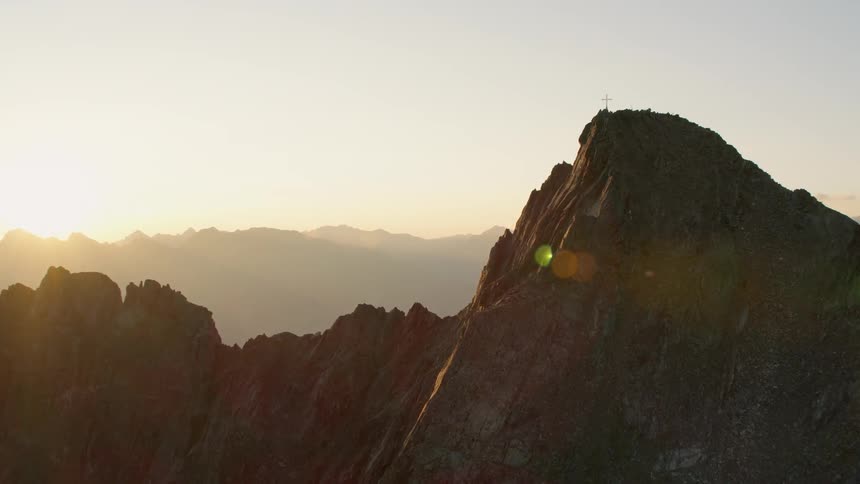 Mountain peaks with patches of snow at sunset