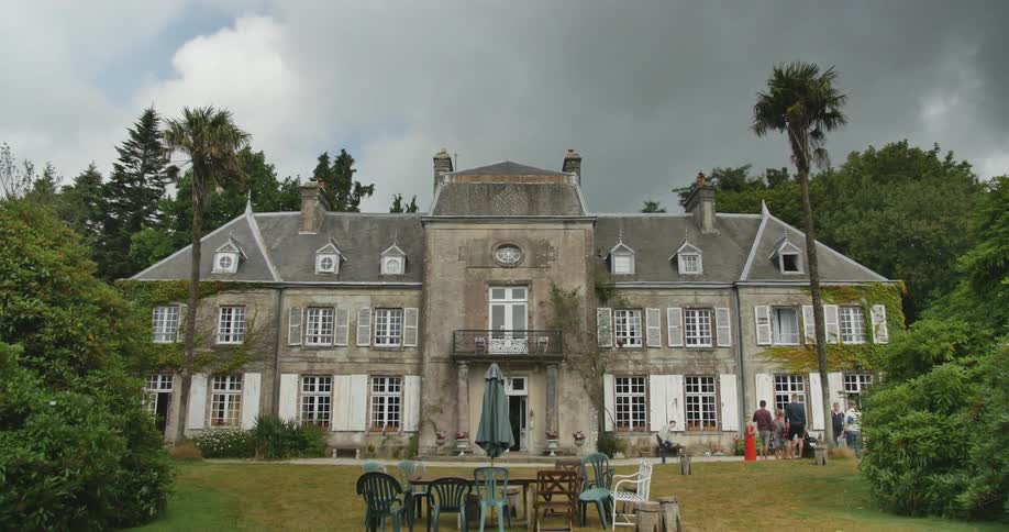 View of an old mansion from the backyard during the day