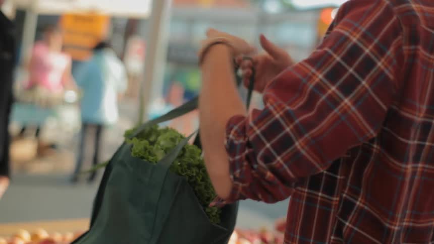A woman is buying groceries