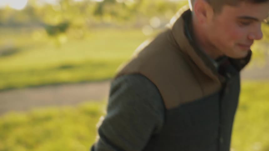 Man walks on the grass on a sunny day