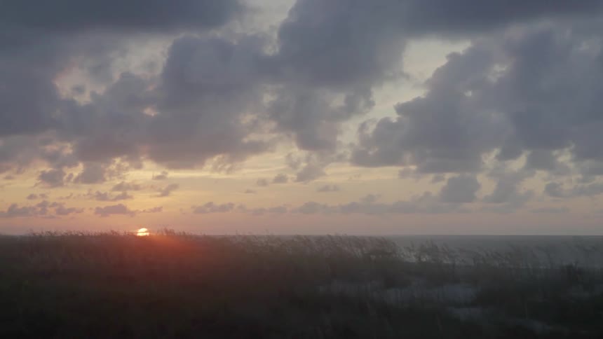 The Sun Rising On A Misty Morning At The Beach