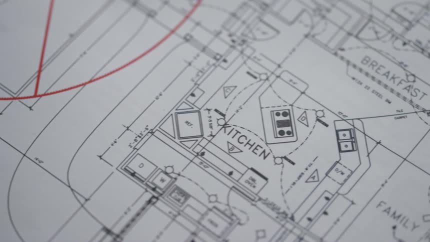 Blueprints with red ink on them