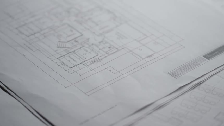 Building blueprints sit on a table