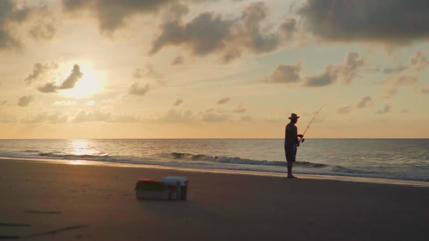 A man fishes on the beach