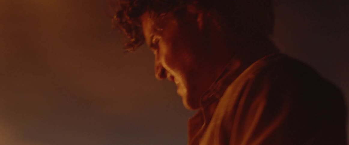 A man is digging dirt trying to put out a flame
