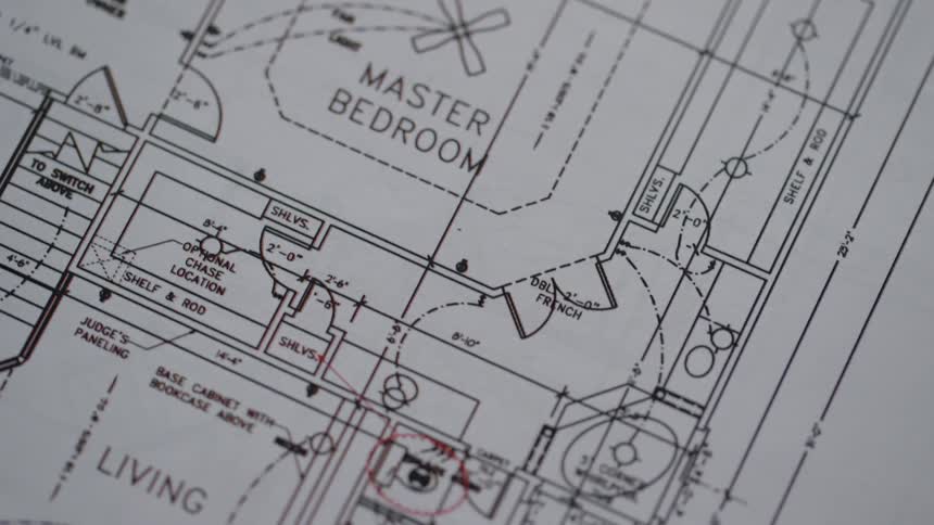 Floor plans for a house are looked at up close