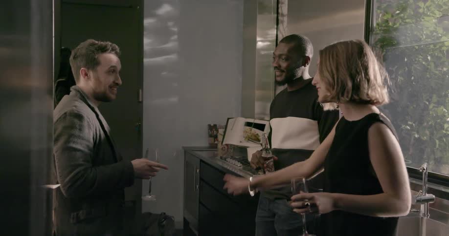 People at a party talk with some drinks in hand