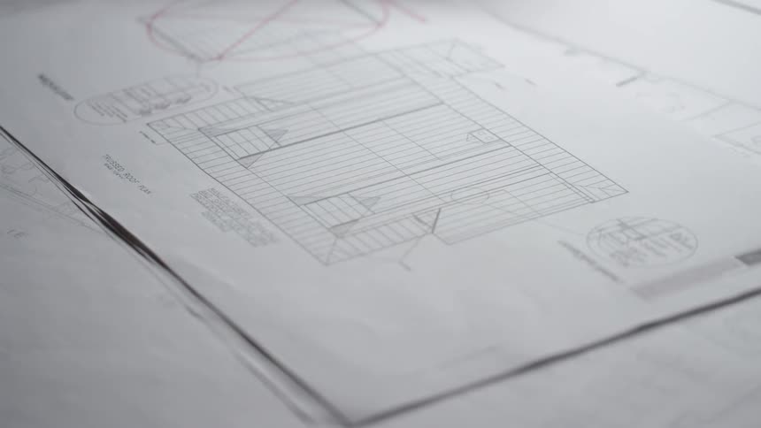 A man turns the page on building plans