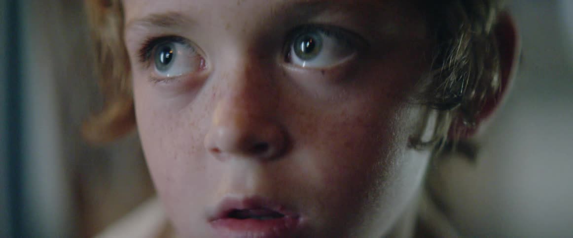 A kid is staring at something off screen