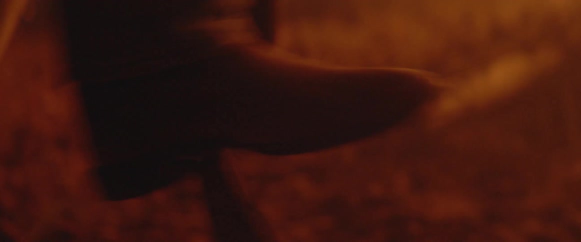 Man shovels dirt onto a fire