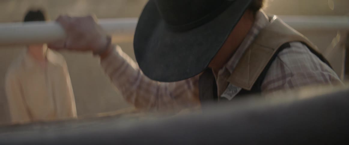 A cowboy is preparing to ride in a rodeo