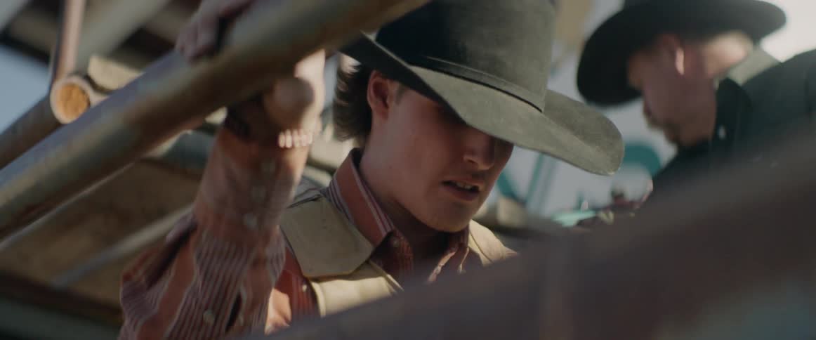 Cowboy prepares to ride a bull out of the chute
