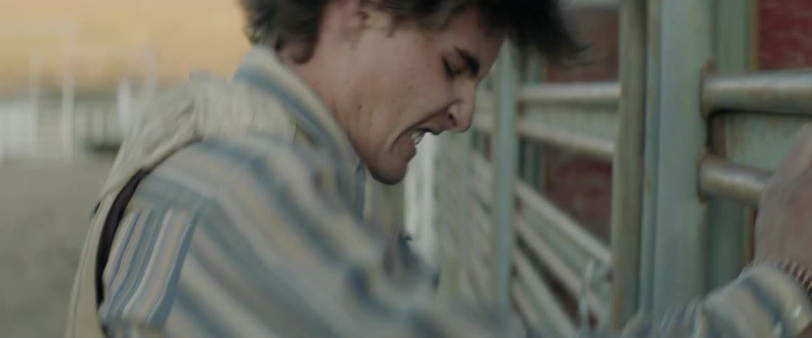 A man hits a fence in frustration