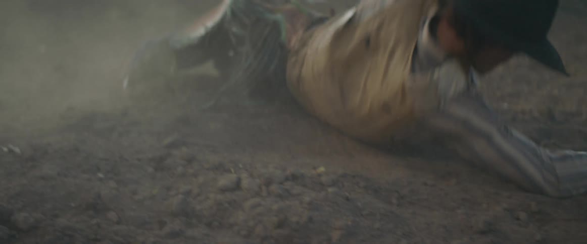 Man rolls on the ground then gets up and runs